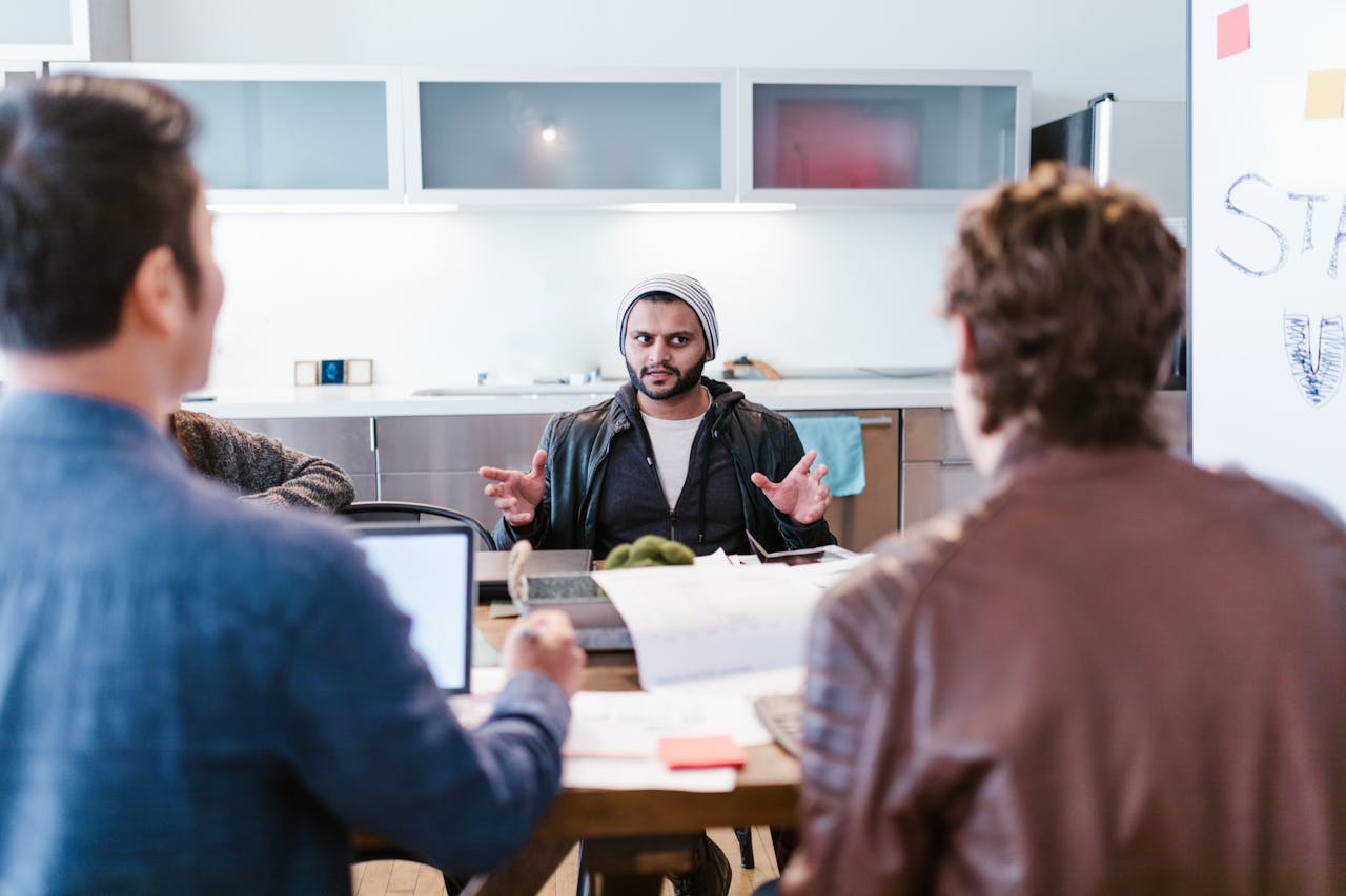 A diverse team gathers for a creative strategy meeting in a modern office setting.